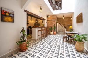 a kitchen with a table and some potted plants at Riad Dar Irdide in Essaouira