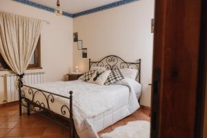 a bedroom with a bed with white sheets and pillows at Arcinazzohouse in Canterano
