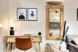 a living room with a desk and a mirror at Tower Hideaway Flat in city centre area of Canterbury in Canterbury