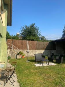 a yard with chairs and a couch and a table at Casa Vilamarín in Santa Eulalia