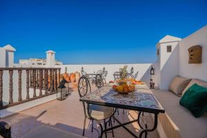 a balcony with a table with fruit on it at Riad Dar Irdide in Essaouira +87 photos
