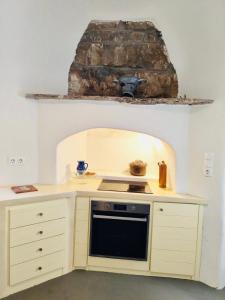 a small kitchen with a stove and a sink at Vista Tinos in Triandáros