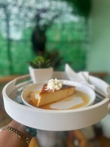 a person holding a plate with a dessert on it at Casa De Las Muñecas RH in Santo Domingo