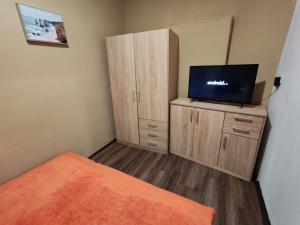 a bedroom with a bed and a flat screen tv at Zo. Low Budget House in Bakonykoppány