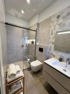 a bathroom with a toilet and a sink and a shower at Brianza Home in Giussano +81 photos