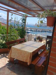 a table and benches on a patio with a view of the water at Apartment Mira in Baška