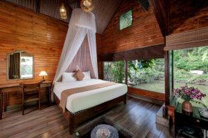 a bedroom with a bed and a window at Tam Coc Lion Kings Hotel & Resort Ninh Binh in Ninh Binh
