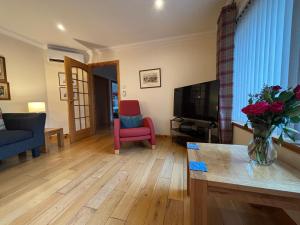 a living room with a vase of flowers on a table at No 1 High Park Lodges in Orkney