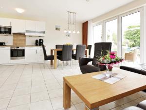 a kitchen and living room with a table and chairs at 6 person holiday home in Großenbrode in Großenbrode +81 photos