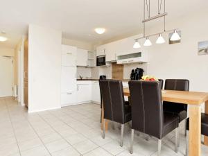 a kitchen and dining room with a wooden table and chairs at 6 person holiday home in Großenbrode in Großenbrode