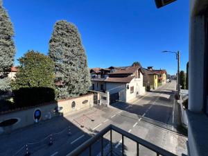 a view of a street with two large trees at Brianza Home in Giussano