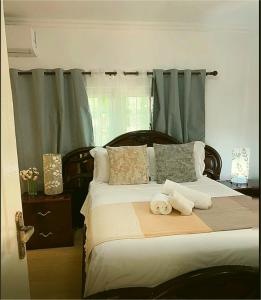 a bedroom with a bed with towels on it at Elilia's Haven in Beau Vallon