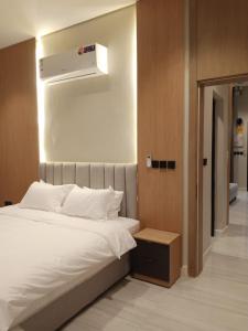 a bedroom with a white bed and a air vent at شاليهات أجواء الريف in Dammam