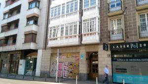 a man walking in front of a building at Pensión Araba II in Vitoria-Gasteiz