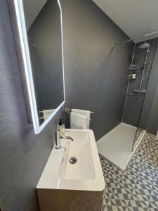 a bathroom with a sink and a shower and a mirror at No 2 High Park Lodges in Orkney +39 photos