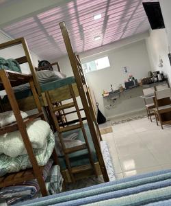 una camera con letti a castello e una cucina con tavolo di Rancho do Viajante Flat APARTAMENTO A a Castro