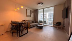 a living room with a couch and a table at סוויטה משפחתית מפנקת בראון 42 אילת in Eilat