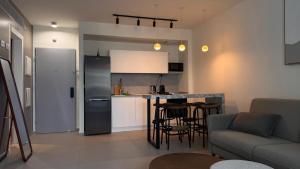 a kitchen and living room with a refrigerator and a table at סוויטה משפחתית מפנקת בראון 42 אילת in Eilat