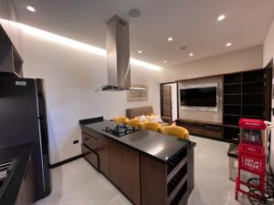 a kitchen with a black counter top and a living room at GZ GUEST HOUSE in Cuenca +27 photos