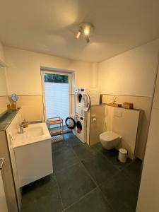 a small bathroom with a sink and a toilet at Strandbude Dangast in Dangast