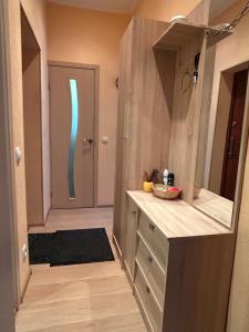 a kitchen with a wooden counter and a door at Ligzdina in Auce +3 photos