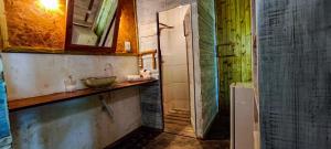a small bathroom with a sink and a mirror at Casa Janjão in Icaraí