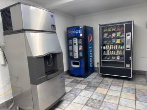 a soda machine next to a drink vending machine at Motel 6-Enfield, CT - Hartford in Enfield