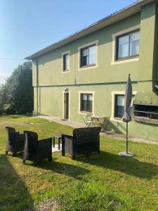a group of benches in front of a building at Casa Vilamarín in Santa Eulalia