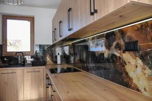 a kitchen with a wooden counter top in a kitchen at Dom pod Tatrami - Brzegi - Bukowina Tatrzańska in Brzegi +25 photos