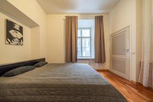 a bedroom with a large bed and a window at Old Town - Best Location Apartment in Tallinn
