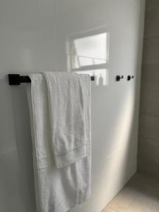 a towel hanging on a towel rack in a bathroom at 2 Bedroom Condo in Sunninghill Sandton in Sandton