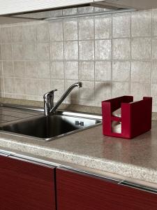 a kitchen counter with a sink and a red box at Residence Cà Mazzini in San Giorgio Di Mantova +36 photos