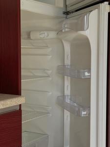 a white refrigerator with glass shelves in it at Residence Cà Mazzini in San Giorgio Di Mantova