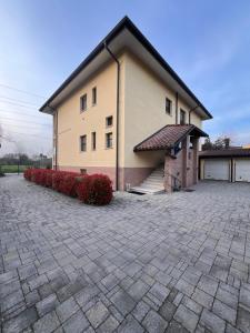 a house with a brick driveway in front of it at Residence Cà Mazzini in San Giorgio Di Mantova