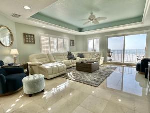 a living room with a couch and a table at Chateaus on White Sands 302 in Clearwater Beach