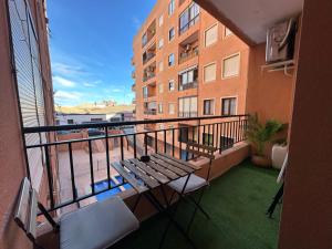 a balcony with a table and chairs and a building at Villa Torrevieja in Torrevieja