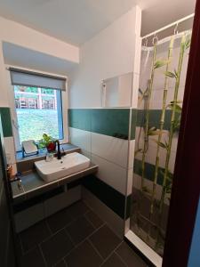 a bathroom with a sink and a glass shower at Parádní chalupa in Semily