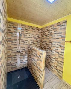 a bathroom with a shower with wooden walls at O'Hani-Ura lodge in Bora Bora