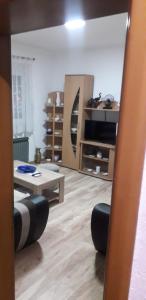 a living room filled with furniture and a table at Apartman Iris in Bosanski Brod