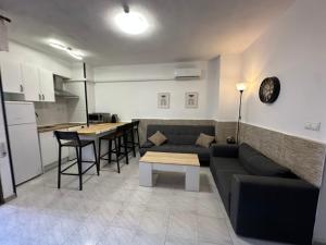 a living room with a couch and a table at Villa Torrevieja in Torrevieja