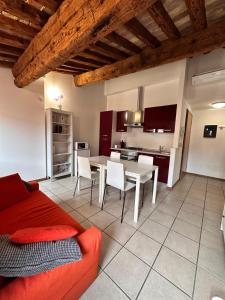 a living room with a red couch and a table at Appartamenti Portavenezia in Padova