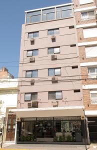 a tall building with a store in front of it at Hotel Zurich in Rosario