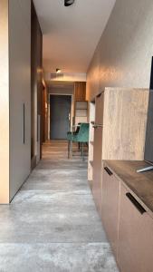 a kitchen with a hallway with a table in it at Svarog Unique Apartment by CHORS in Bratislava