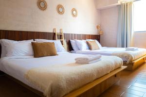 two beds in a hotel room with towels on them at Destiny Hotel - 1605 in Sampong