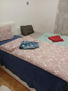 a bedroom with two beds with clothes on them at B&BAnjanaS in Vaggeryd +9 photos