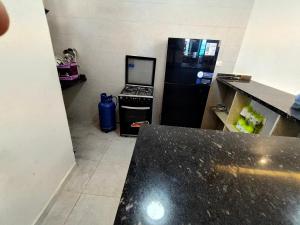 a kitchen with a black refrigerator and a stove at Luxury units for rent on the sea in Marsa Matruh