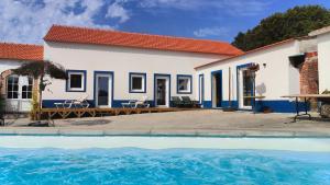 a house with a swimming pool in front of it at Casa da Paraventa in Gaieiras