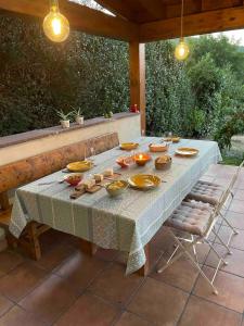 a table with bowls and plates on it on a patio at The Walnut tree in San Miguel de Luena