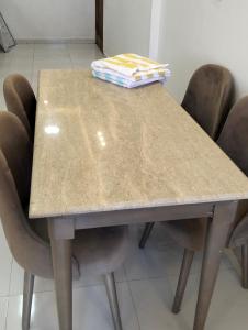 a table with four chairs and a box on top at Luxury units for rent on the sea in Marsa Matruh