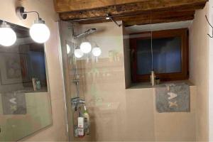 a bathroom with a shower with a glass door at The Walnut tree in San Miguel de Luena +43 photos